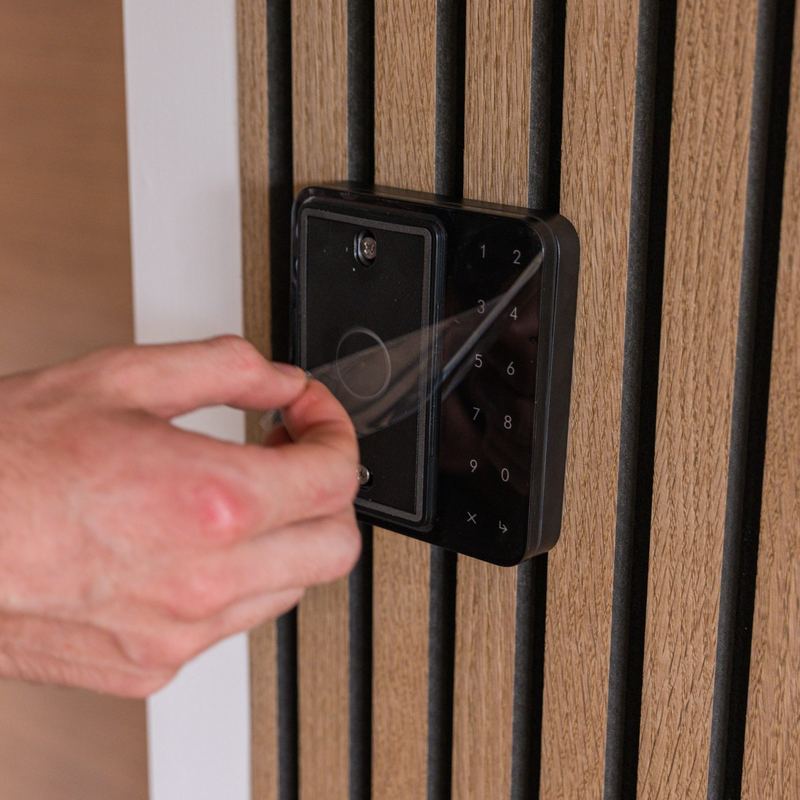 A customer entering with a phone on the door access reader
